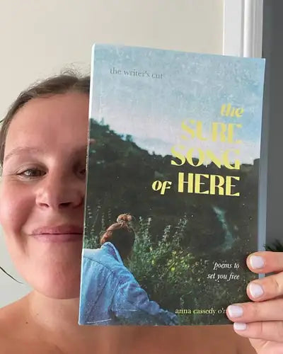 Author holding The Sure Song of Here